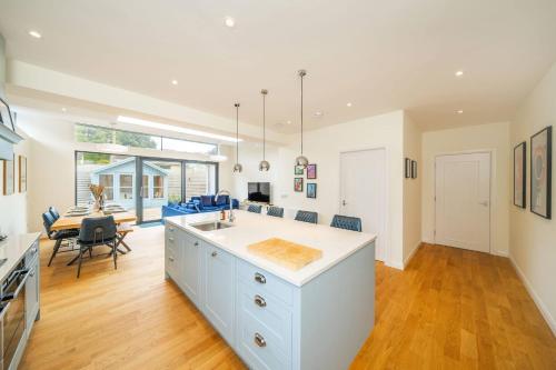 a kitchen with a sink and a dining room at Newhall Gardens in Invergowrie