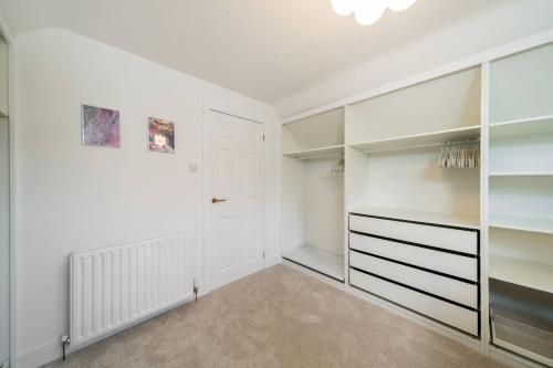 a walk in closet with white walls and a white door at Taigh Tatha in Broughty Ferry