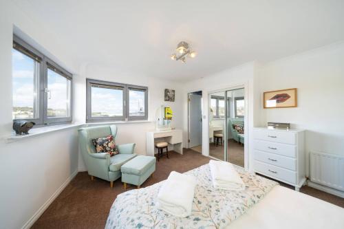 a bedroom with a bed and a chair and a desk at Twin Bridges in Dundee