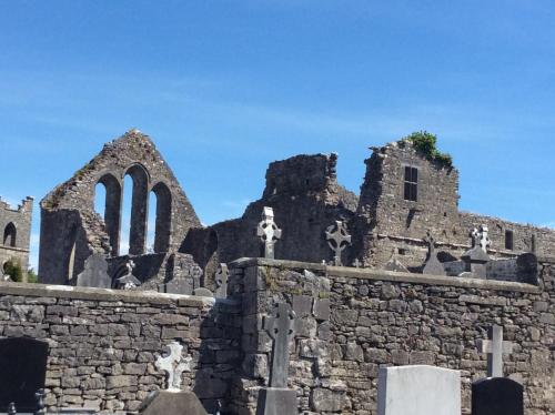 an old stone church with tombstones and crosses at Ryan's River Lodge B&B in Cong