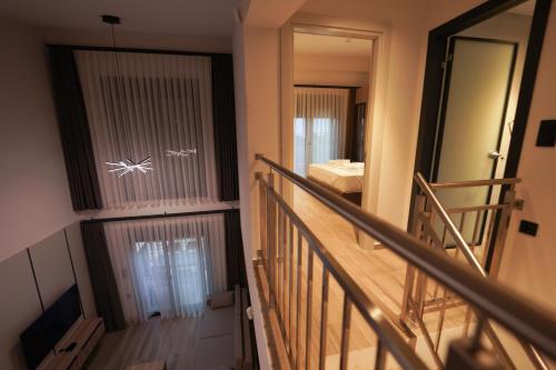 a staircase leading to a room with a mirror at Sunrise Luxury Apartments in Fanárion