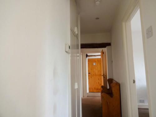 an empty room with a door and a window at Emily's View, Ireby in Ireby