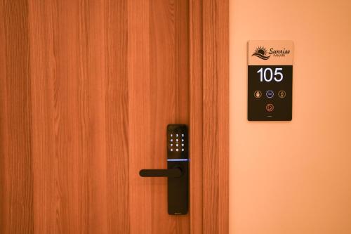 a door with a clock on the side of it at Sunrise Luxury Apartments in Fanárion
