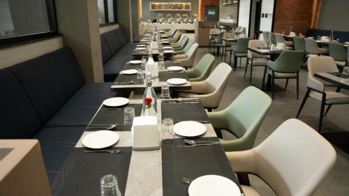 a long row of tables in a restaurant at Zip By Spree Hotels Chinchwad in Chinchiwad