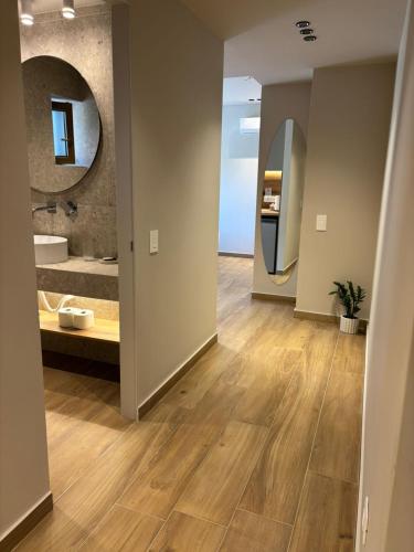 a hallway with a bathroom with a sink and a mirror at ΝΕΑΚΙΤΟΣ Luxury Apartments in Nikiti