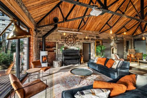 a living room with a couch and a fireplace at The Stables in Dundee
