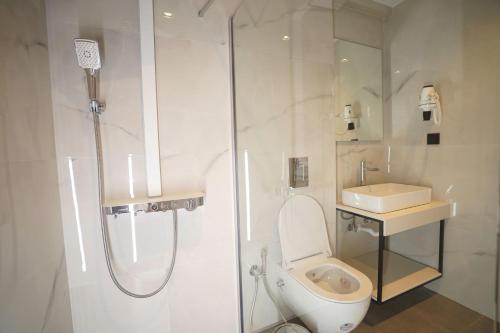 a bathroom with a shower and a toilet and a sink at Sunrise Luxury Apartments in Fanárion