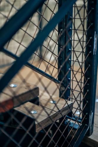 a wire cage with a wooden box on a shelf at The Stables in Dundee