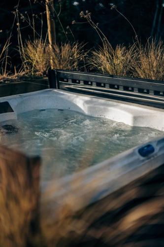 a bath tub with water in it at The Stables in Dundee