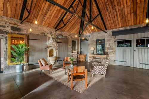 a living room with furniture and a wooden ceiling at The Stables in Dundee