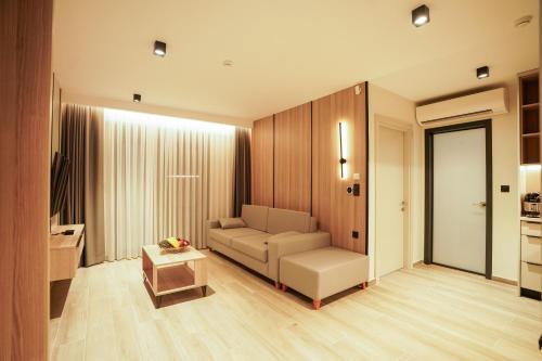 a living room with a couch and a table at Sunrise Luxury Apartments in Fanárion