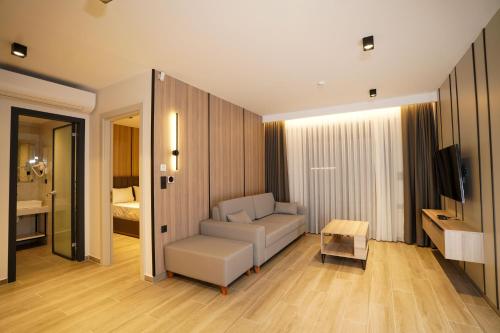 a living room with a couch and a table at Sunrise Luxury Apartments in Fanárion