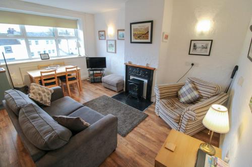 a living room with a couch and a fireplace at Emily's Apartment, Ireby in Ireby