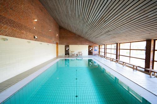 a large swimming pool in a large building at Bymose Hegn Hotel & Kursuscenter in Helsinge