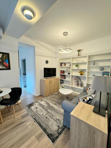 a living room with a blue couch and a table at Hot Spot - Apartment - Sanador Victoriei in Bucharest