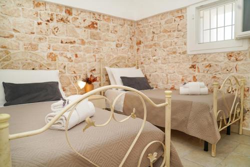 Postel nebo postele na pokoji v ubytování trullo lantane