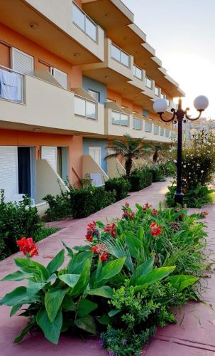 a building with red flowers and a street light at Yms studios in Rethymno Town