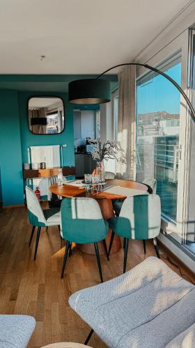 a dining room with a table and some chairs at Just Sunny - Rooftop mitten in der Stadt in Basel