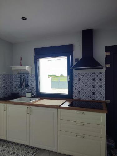 a kitchen with a sink and a window at O barco de Coto in Barreiros