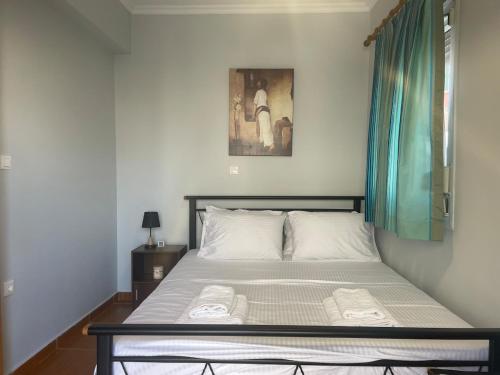 a bedroom with a bed with two towels on it at Vasilakis Apartments 3 in Chios