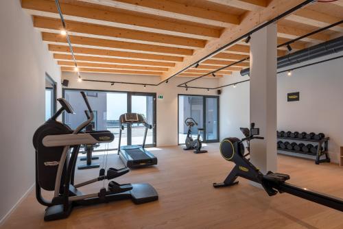 a gym with treadmills and exercise equipment in a building at Hotel Royal Village in Limone sul Garda