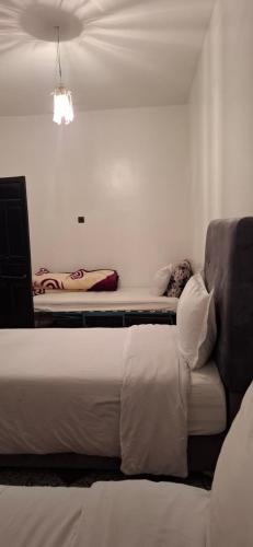 a hotel room with a bed and a couch at Dar Noureddine in Lalla Takerkoust