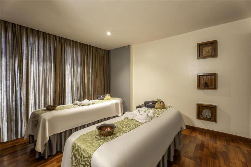 a hotel room with two beds and a window at Radisson Blu Hotel Pune Kharadi in Pune