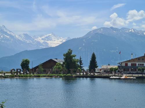 a large body of water with mountains in the background at Appartement proche remontées refait à neuf in Crans-Montana