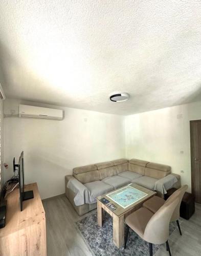 a living room with a couch and a table at Apartment Trifunovi 2 in Kochani