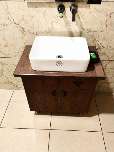 a white sink on a counter in a bathroom at Hotel sky heights in Sonīpat