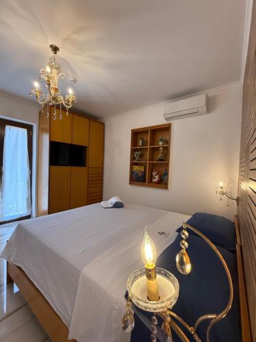 a bedroom with a bed with a candle on a table at Kapo Azzurro in Monterotondo