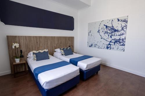 Postel nebo postele na pokoji v ubytování Grand Hotel Tiberio
