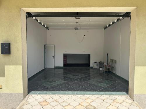 a large empty room with a tile floor and white walls at Apartments Naresi Mostar in Mostar