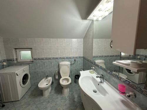 a bathroom with a sink and a toilet and a bidet at Apartments Naresi Mostar in Mostar