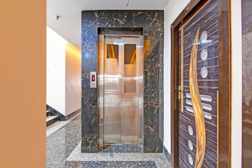 a hallway with a elevator in a building at FabHotel BN Palace - Near Belgharia expressway in kolkata
