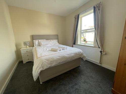 a small bedroom with a bed and a window at Ouse River Quay Hill Lodge in Littleport