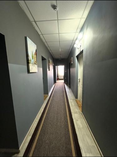 an empty hallway in an office building with a long corridor at Welcome 24 Mukachevo in Mukacheve