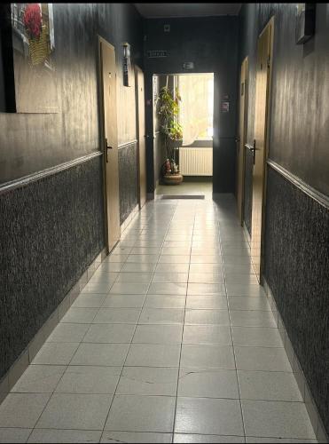 a hallway with doors and a tiled floor at Welcome 24 Mukachevo in Mukacheve