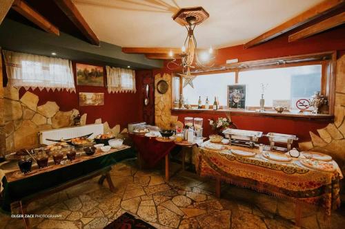 a room with two tables with food on it at Vila Eden Boutique Hotel in Korçë