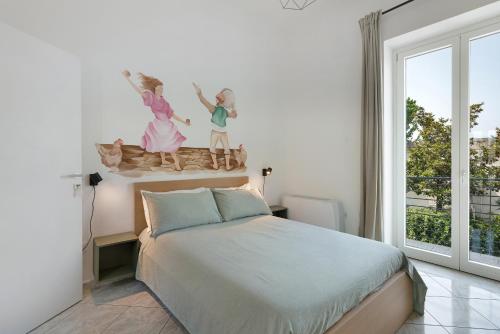 a bedroom with a bed and a large window at Grimaldi Rooms in Pagani