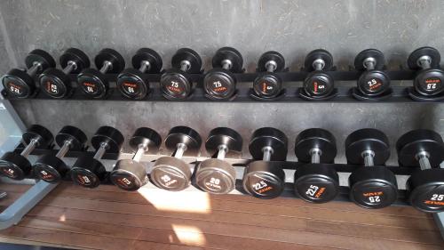 a row of black dumbbells on a wall at Namkat Yorla Pa Resort in Ban Kat