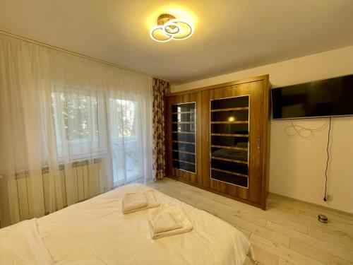 a bedroom with a bed and a large window at Sea & Stay in Constanţa