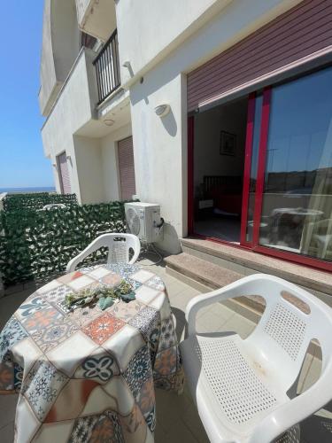 a table and chairs on the balcony of a house at Hotel Lungomare Brancaleone in Brancaleone Marina