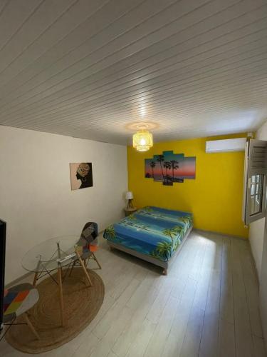 a room with a bed and a table in it at Colibri in Fort-de-France
