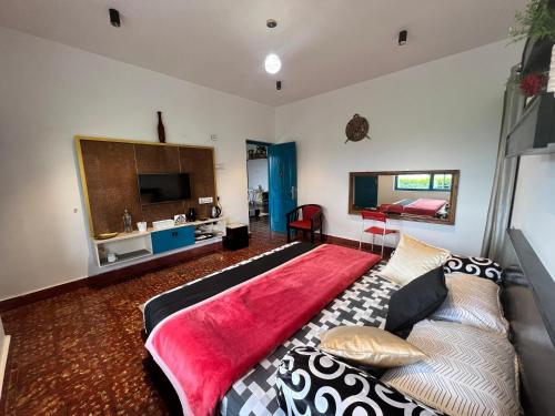 a bedroom with a large bed and a couch at Green Leaves The Countryside Inn in Ooty