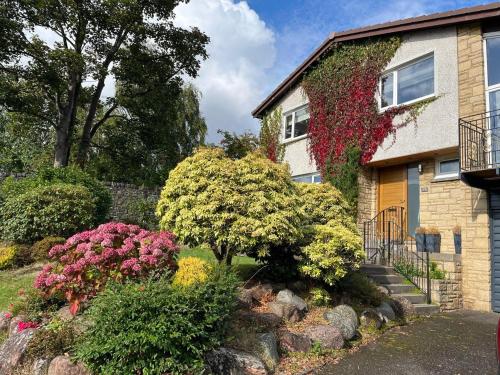 a house with a bunch of flowers in front of it at 4-Bed Seaside Dream House - Sleeps 8 & Parking in Dundee