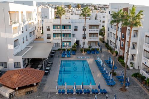 an overhead view of a swimming pool in a building at Kefalos Damon Hotel Apartments in Paphos City