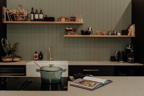 a kitchen with a pot on top of a stove at The Barn - On Cockatoo Lane in Sandy Creek