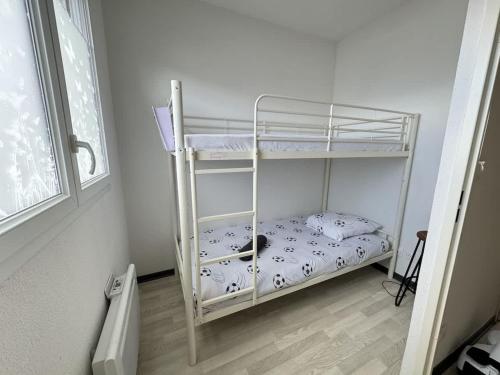 - une chambre avec un lit superposé avec un chat dans l'établissement Valras-Loc La Dune - Brise Marine Elegance Cotiere, à Sérignan