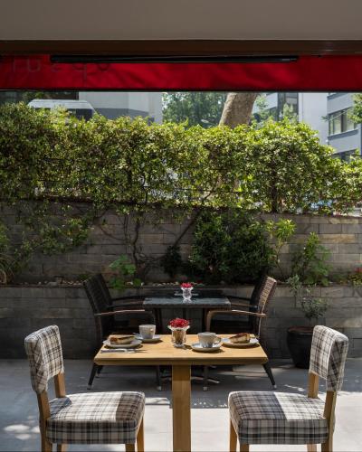 a table with two chairs and a table with food on it at Upsuites Hotel in Istanbul